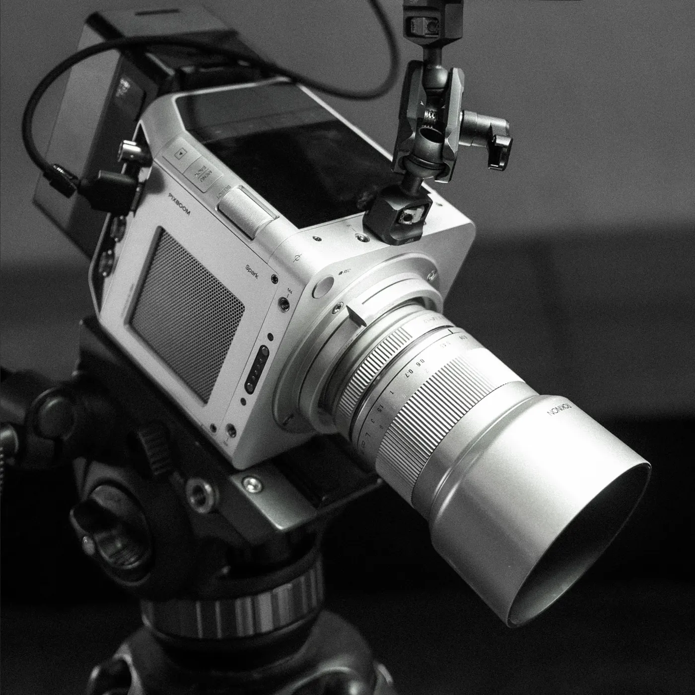 A Spark camera with a long macro lens on a tripod, set up for a tabletop product shot